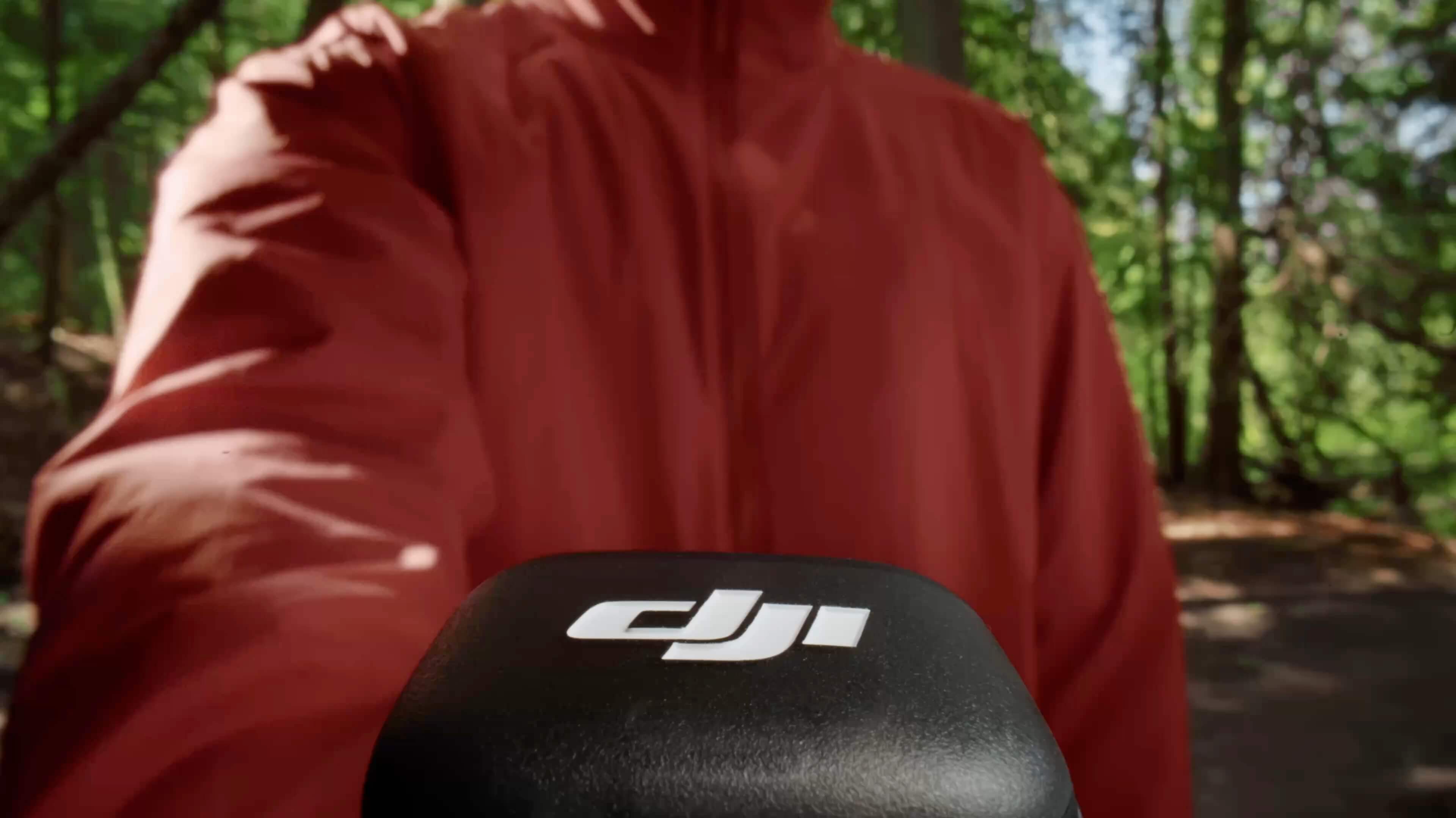 A DJI Mic 3 wireless lavalier microphone system — the magnetic-back transmitter and slim receiver represent the next-gen design hybrid shooters are switching to in 2026