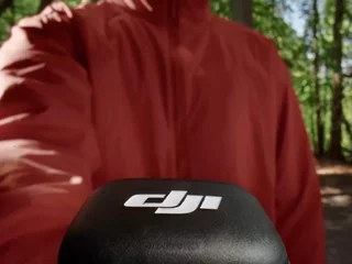 A DJI Mic 3 wireless lavalier microphone system — the magnetic-back transmitter and slim receiver represent the next-gen design hybrid shooters are switching to in 2026