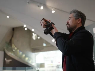 Sigma 15mm f/1.4 lens in hand