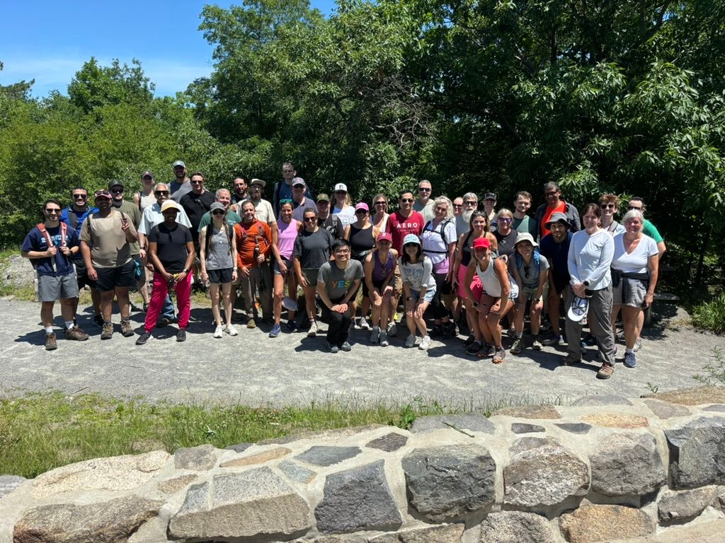 A group of hikers posing at the top of the Blue Hills.