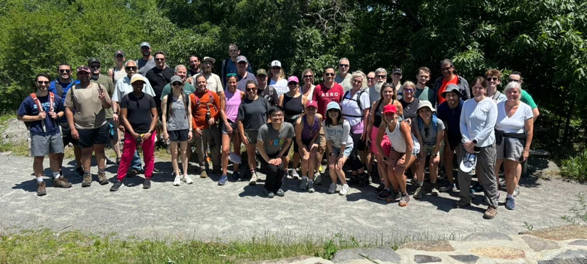 A group of hikers posing at the top of the Blue Hills.