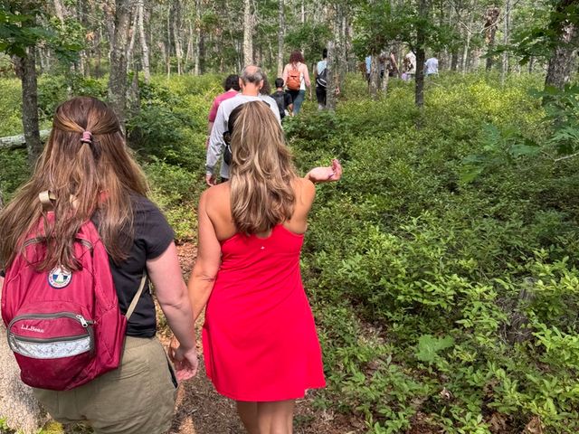 Members hiking a wooded trail at the Cape Cod kickoff hike