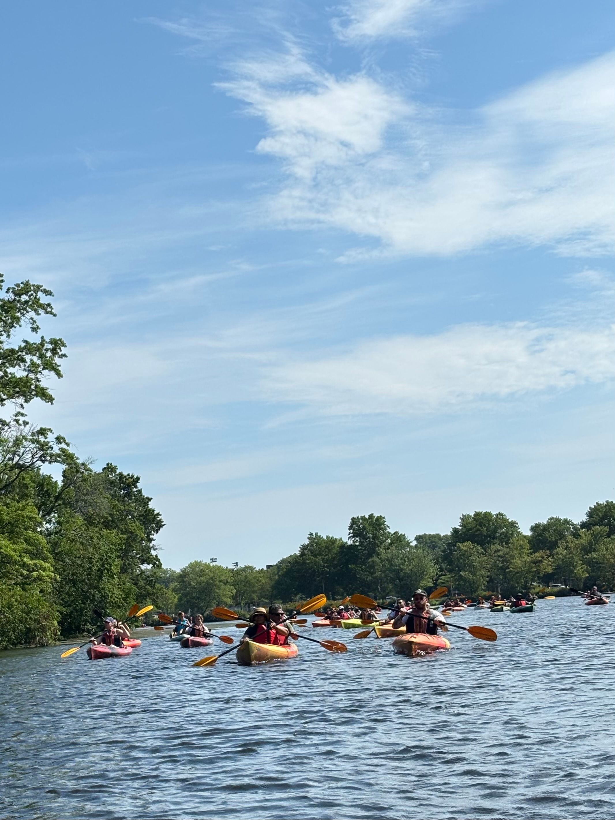 A large group of kayaks on the Charles River.