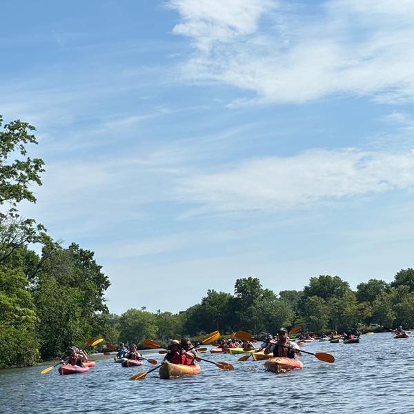 A large group of kayaks on the Charles River.