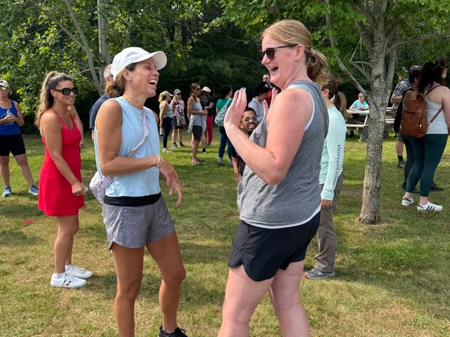 Two members laughing together at a Sober & Curious Boston event