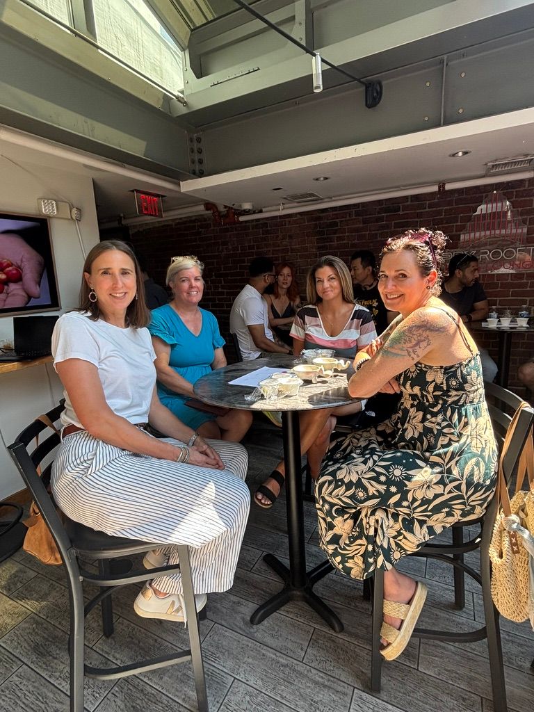 Four women seated at a table at a coffee tasting.