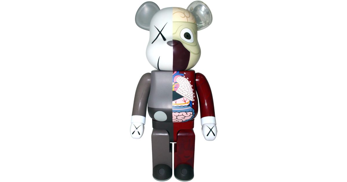 A "dead" Bearbrick in grey on one side, the other exposing "directed" internal organs.