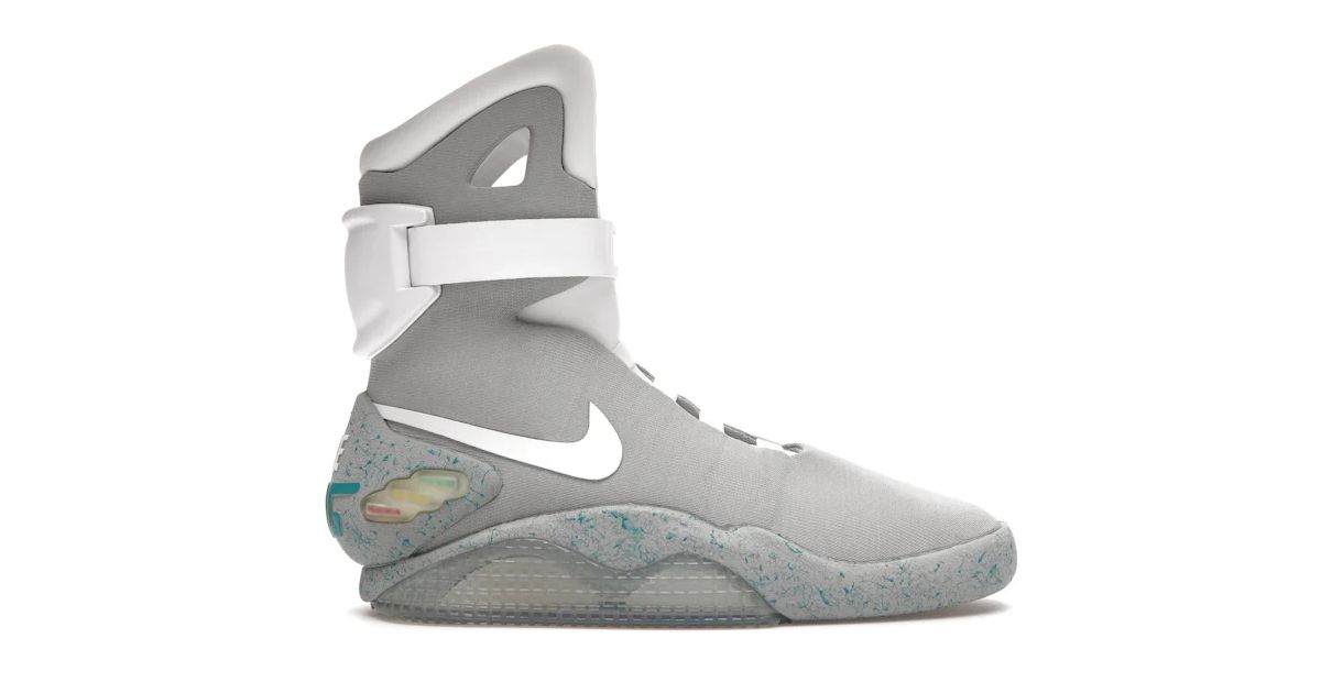 A gray high-top shoe featuring the Nike Swoosh in white down the sidewall, an ankle strap, and a midsole speckled in blue.