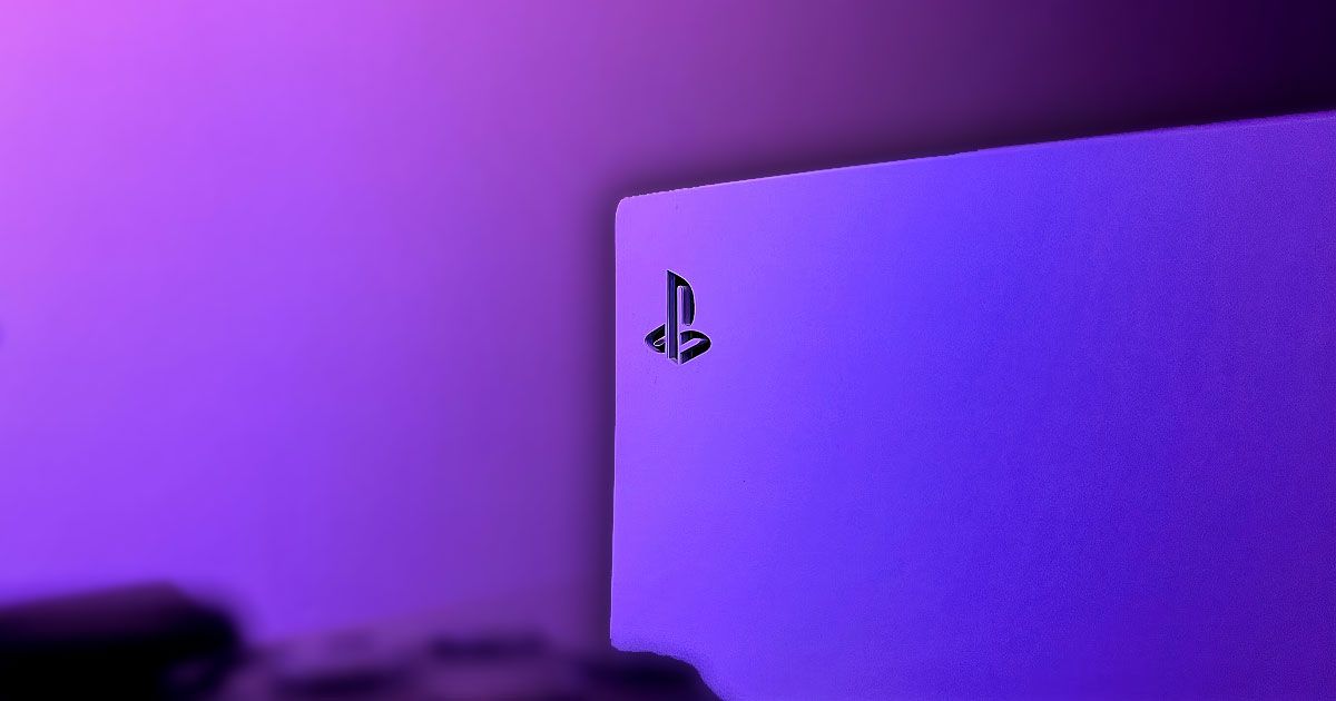 A close up of a white PS5 console bathed in purple and pink light.