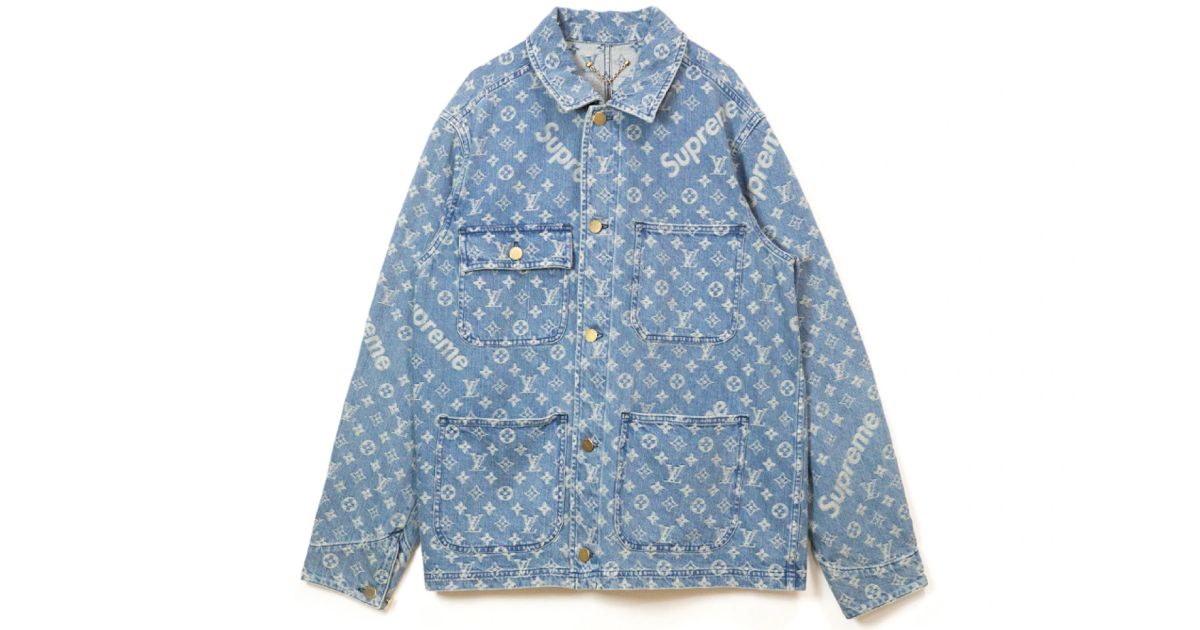 A light blue jacquard denim jacket with a Supreme and LV pattern in white across it.