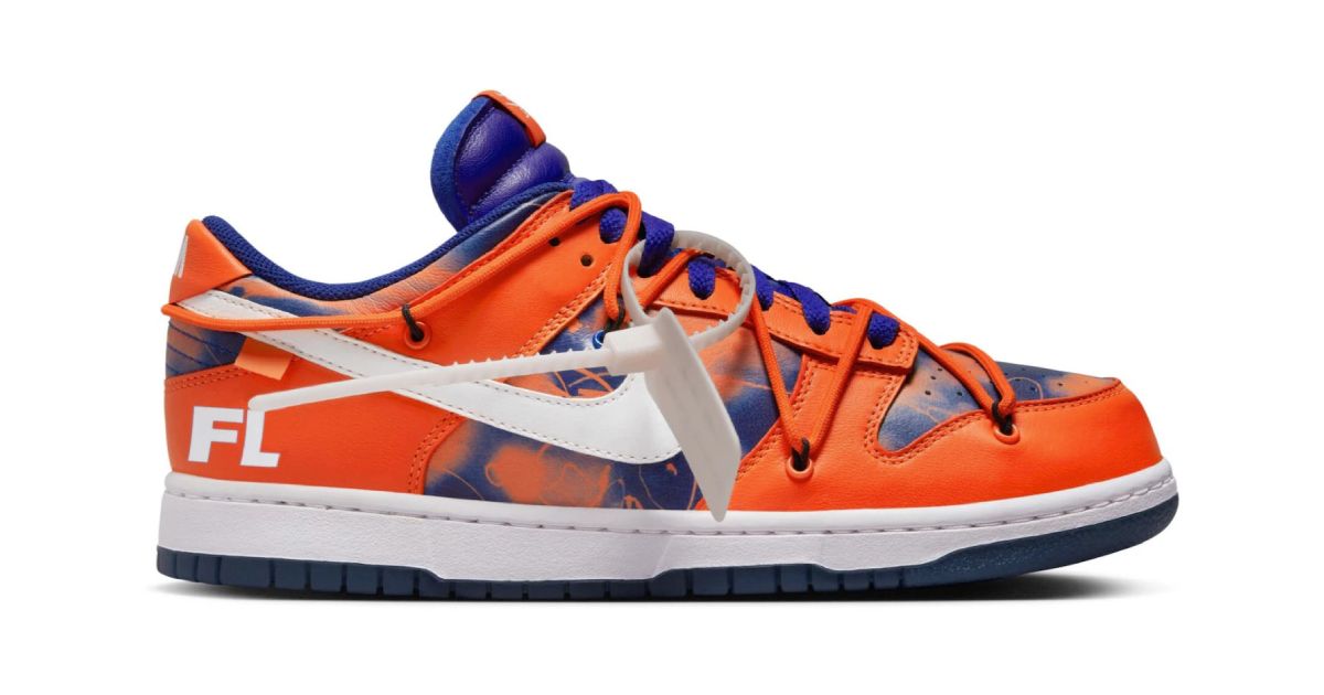 An orange and blue Nike Dunk Low featuring a white midsole and Swoosh down the side to match the lace tag.