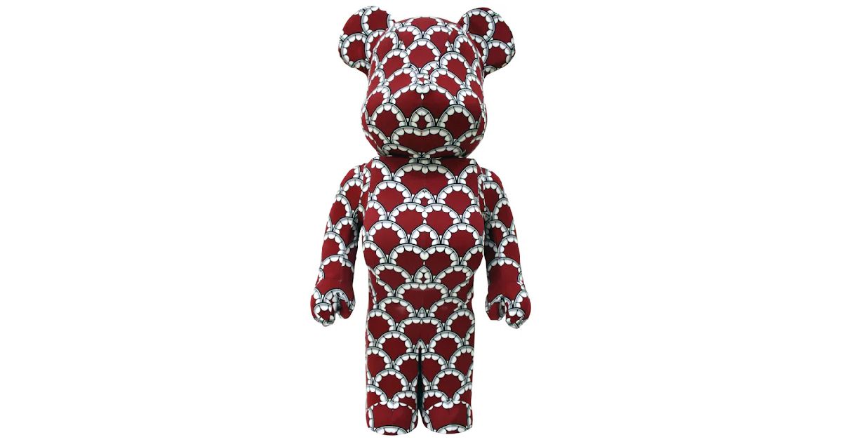 A red Bearbrick with a white pearl-like pattern all over it.