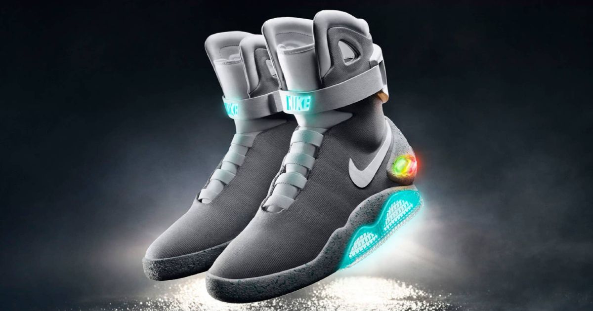 A pair of Nike MAG high-top shoes featuring blue, green, and red lights and a white Swoosh down the sidewall.