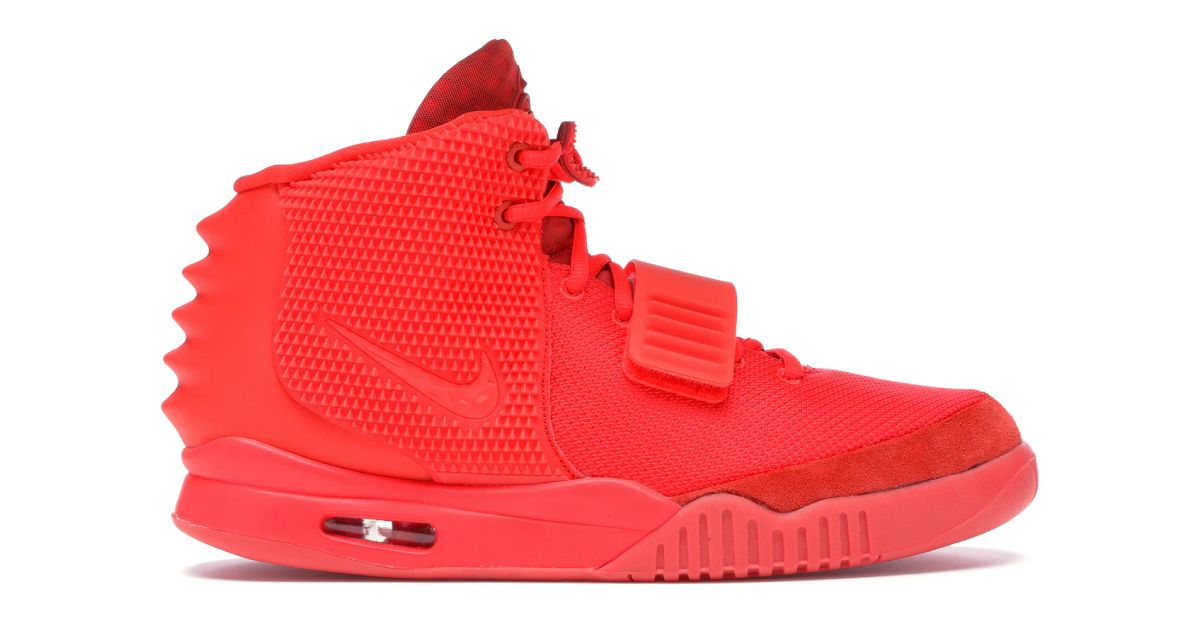 An all-red Nike Yeezy featuring a window in the sole showcasing Air bubbles.