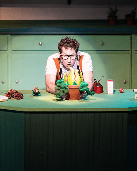 Tim Dolan performing on stage in character