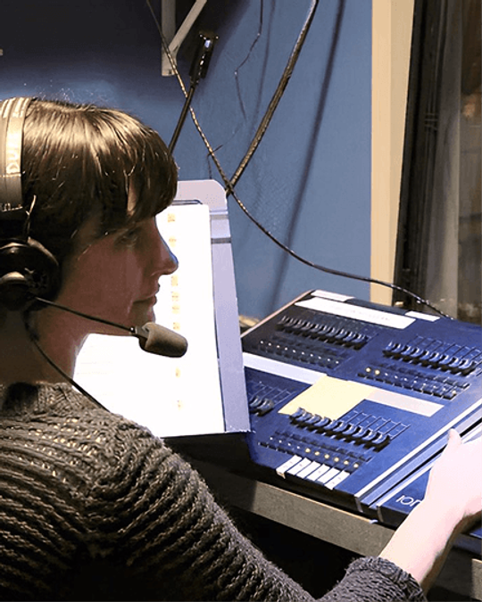 Theresa Flanagan running the lighting board backstage