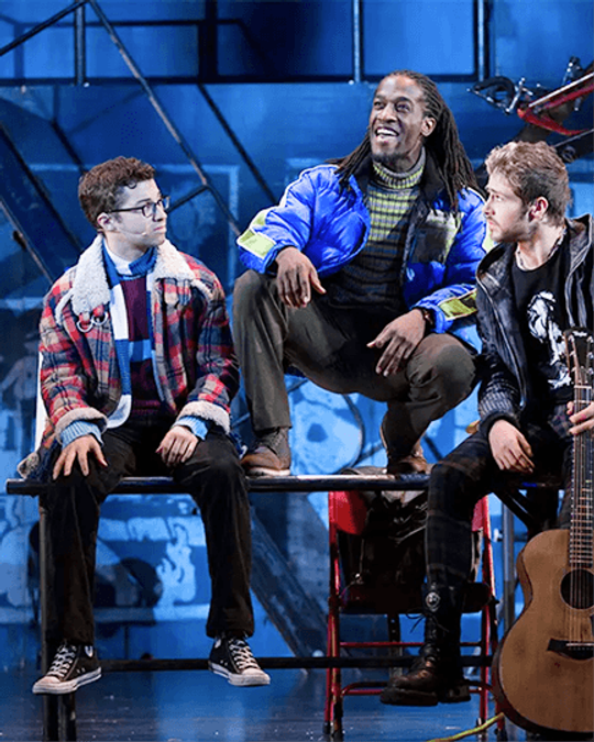 Logan Marks performing in a scene with fellow cast members