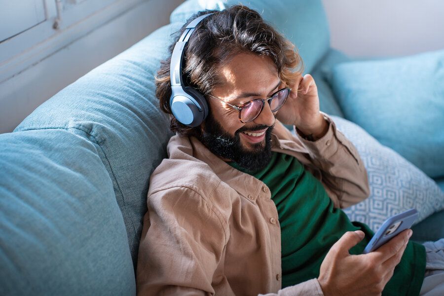 Man listening to headphones - it is important to protect your hearing 