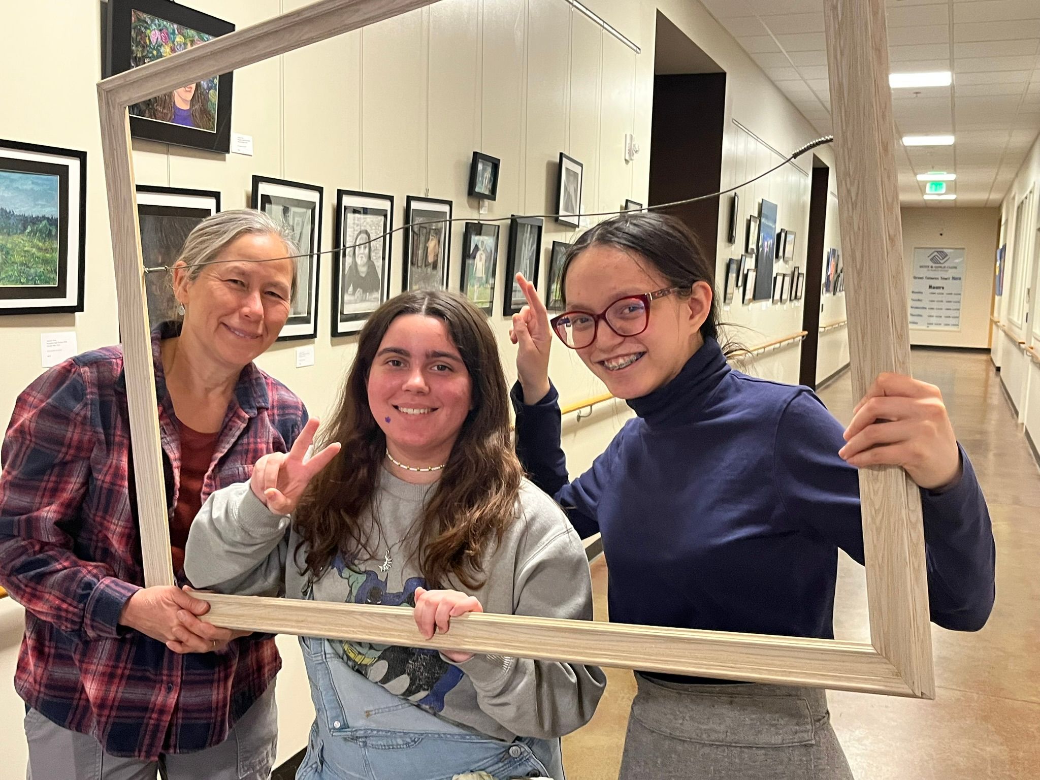 photo of the gallery and artists through a picture frame