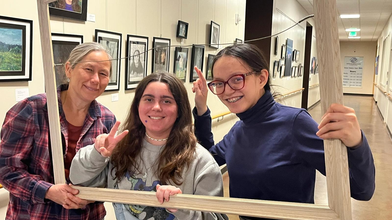 photo of the gallery and artists through a picture frame
