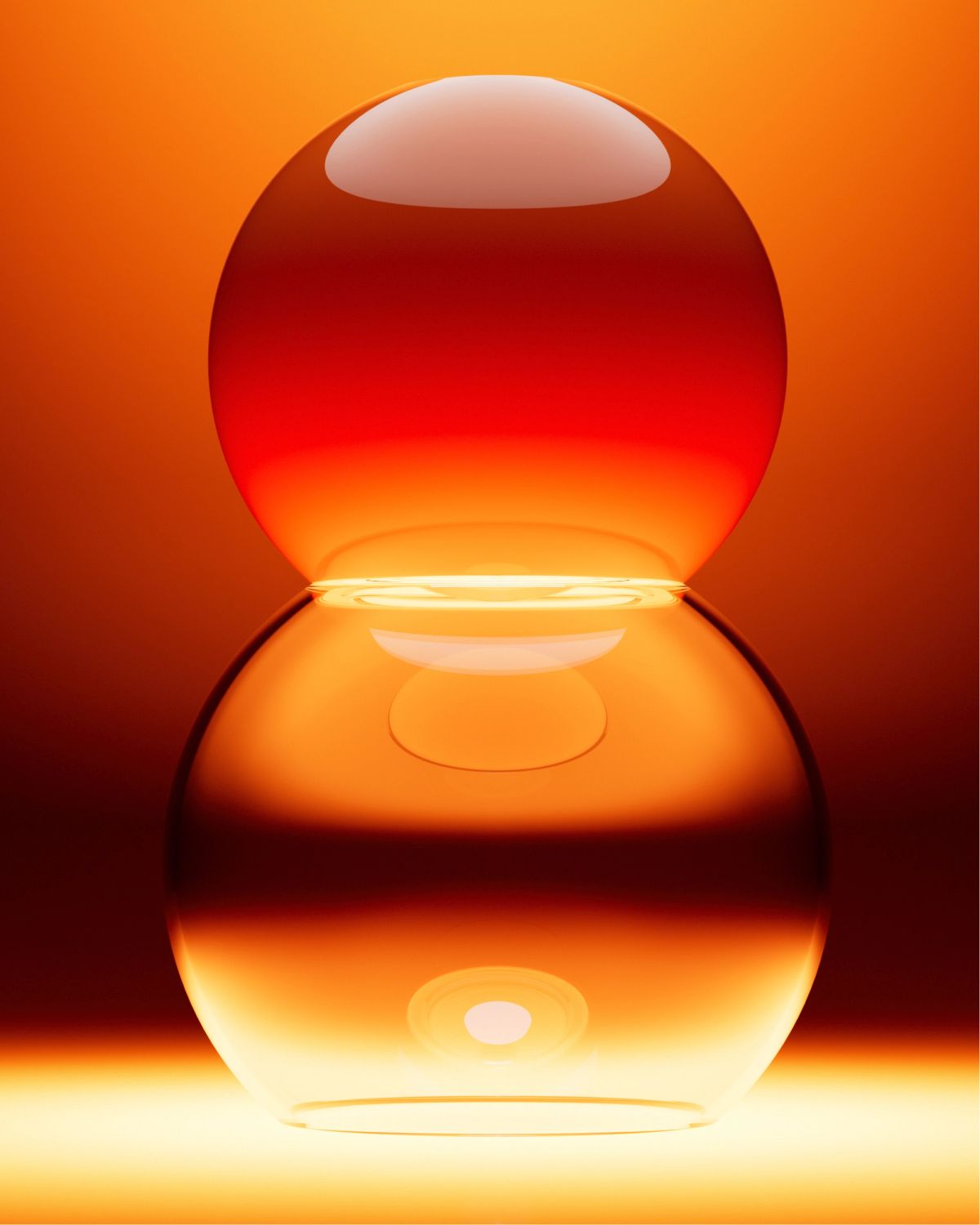 Moon Lamp by ARWENN: two stacked glass spheres, the lower one glowing warmly where they meet, set against an amber-to-deep-red gradient.