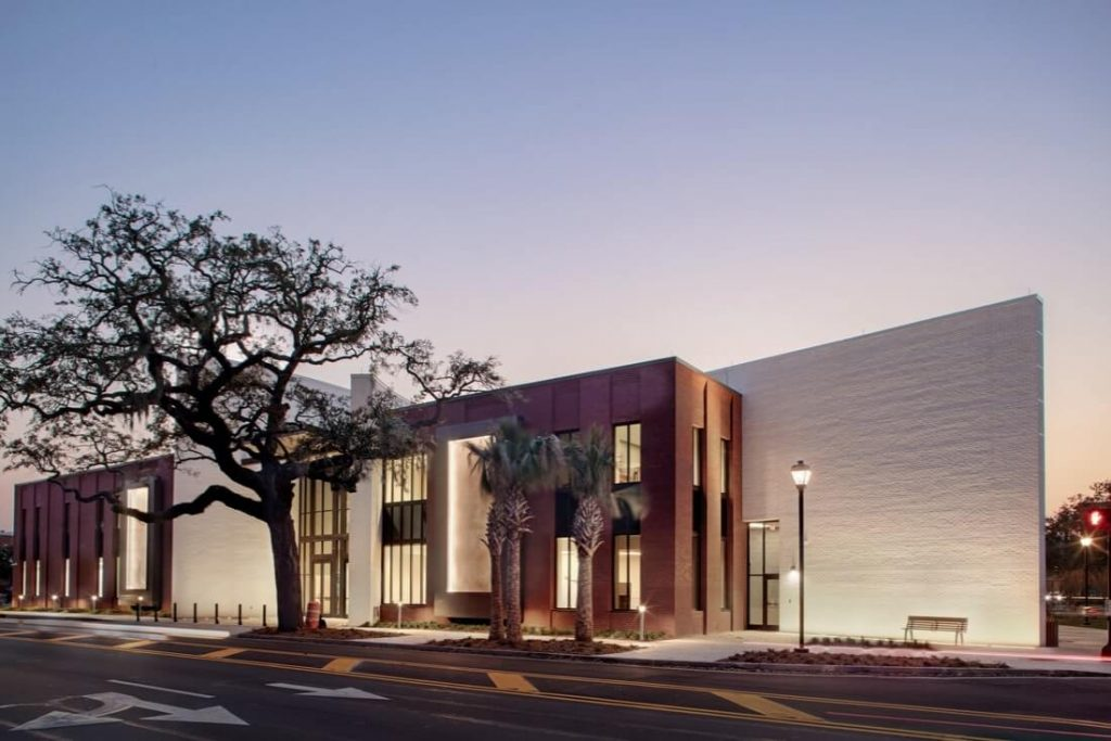 The Savannah Cultural Arts Center at dusk, with a live oak and palms out front