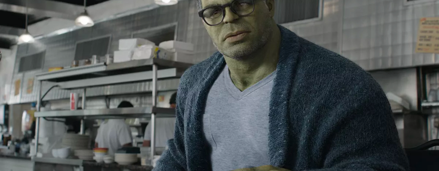 The Hulk (Bruce Banner) with glasses and a cardigan in front of pancakes