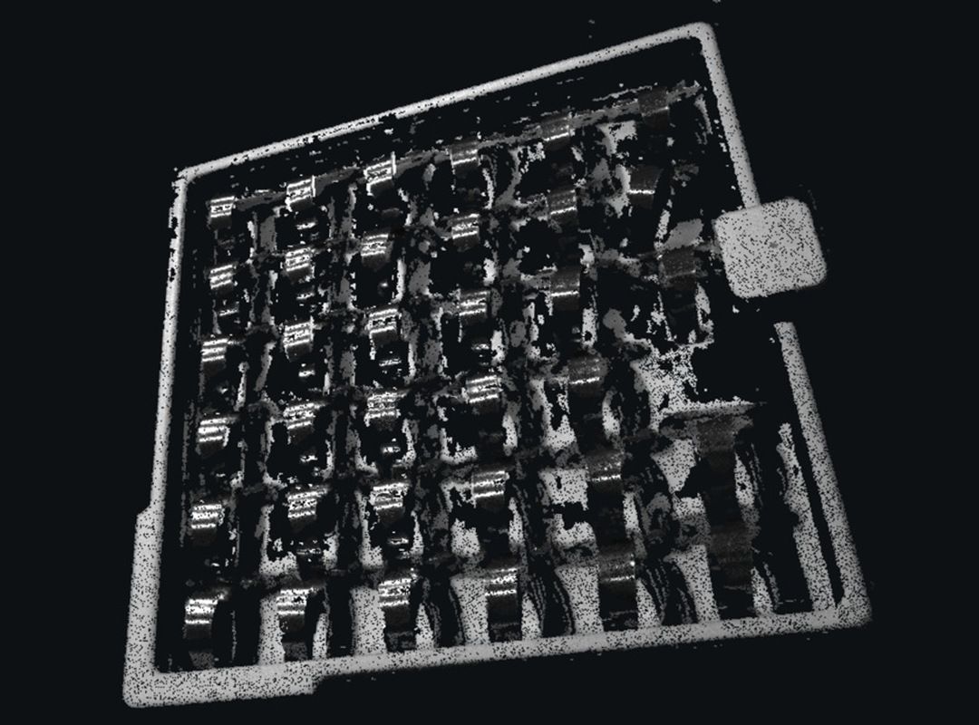 Point cloud of a tray of shiny metal clips from a structured-light camera, with gaps on the reflective surfaces