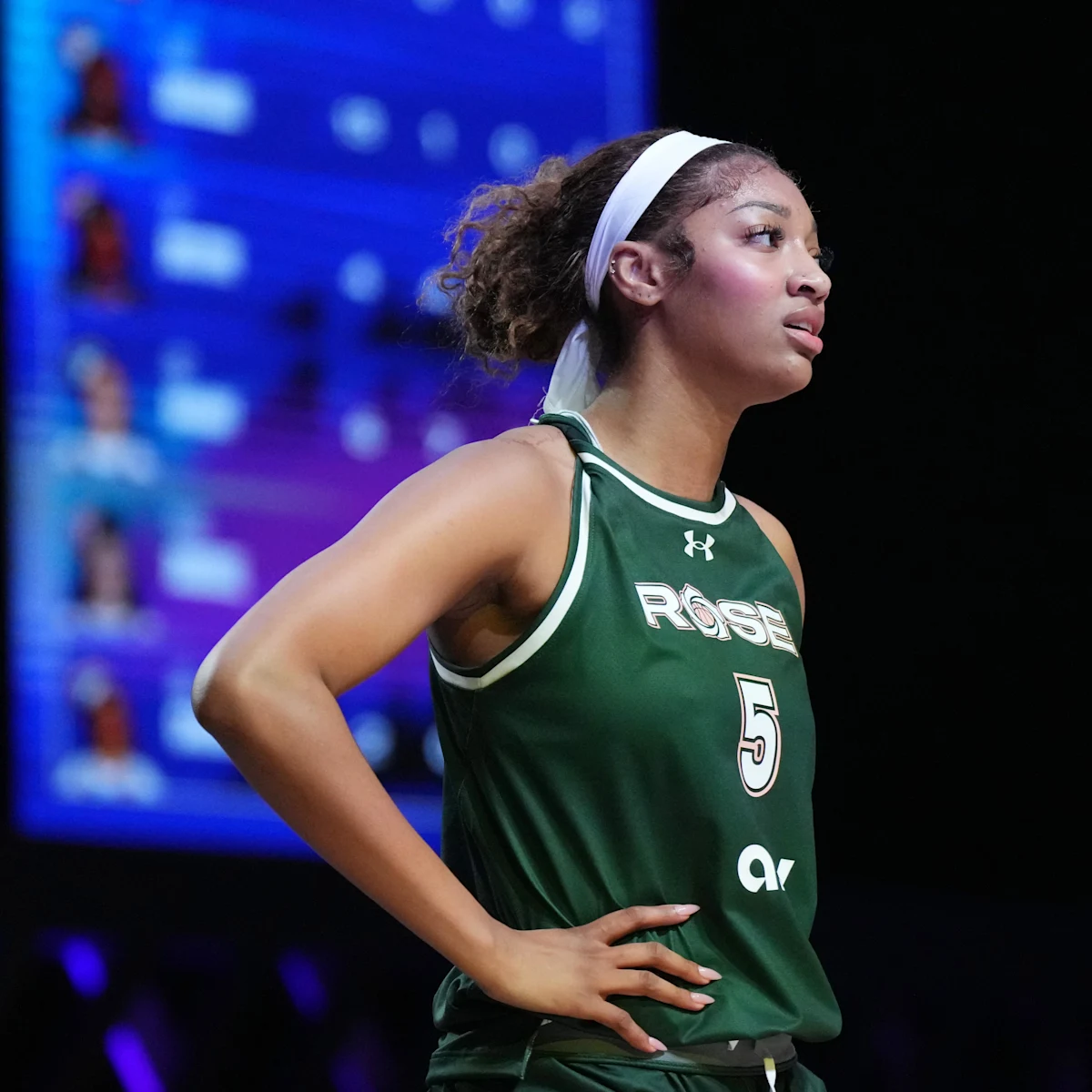 Angel Reese promotes "BARBIE HOOPS ARE BACK" with a stunning Rose Jersey photograph.