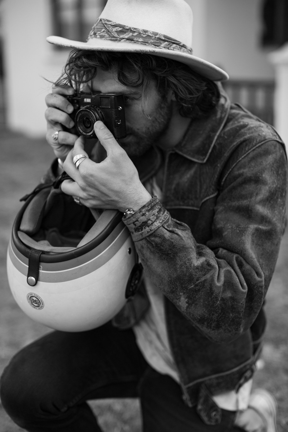 Teddy Jansen taking a photo, a motorcycle helmet under his arm
