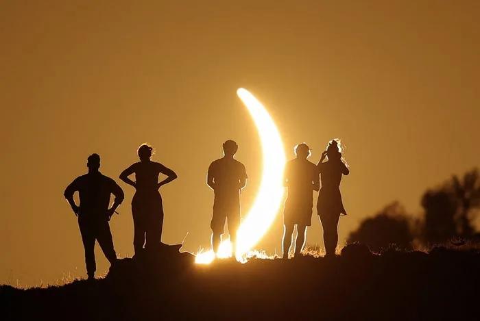 Rare solar eclipse draws crowds of people around the world. See photos