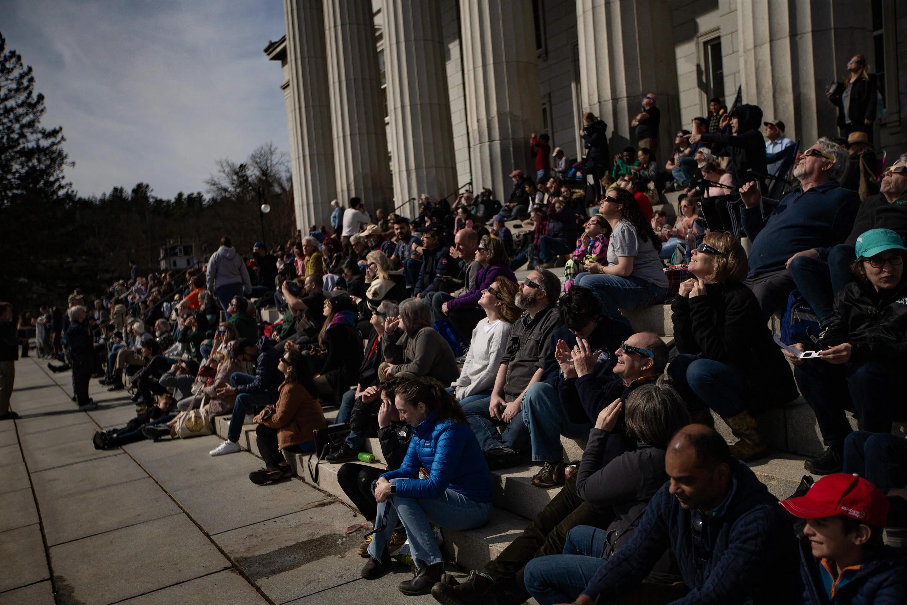 Photos: People watch in wonder as eclipse blots out the sun | WBUR News