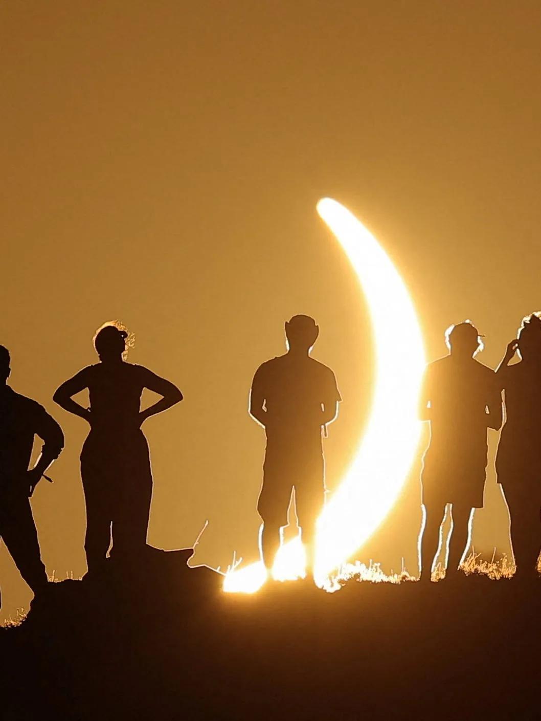 Rare solar eclipse draws crowds of people around the world. See photos