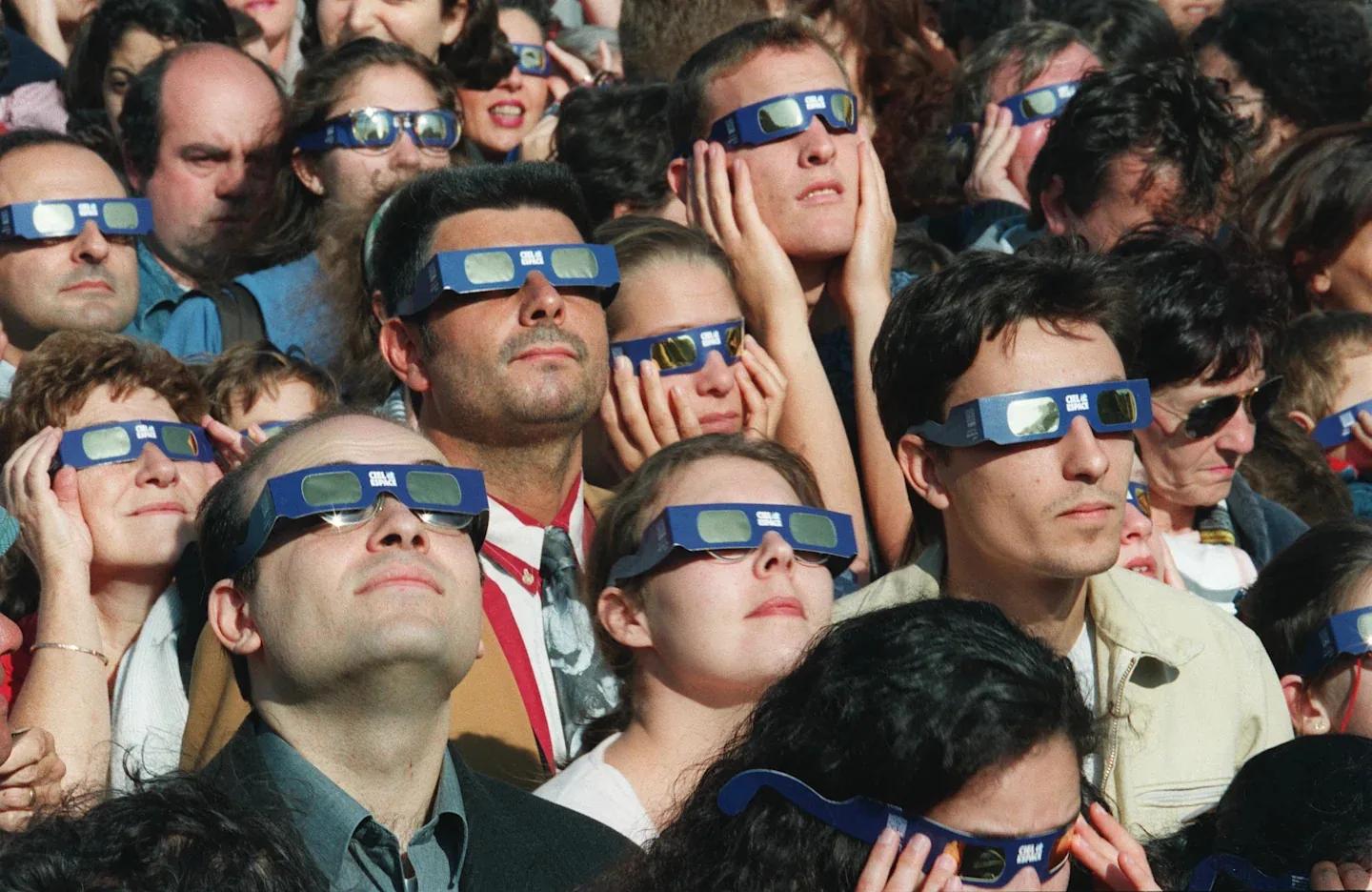 Photos of people looking at solar eclipses from 1907 to the present day