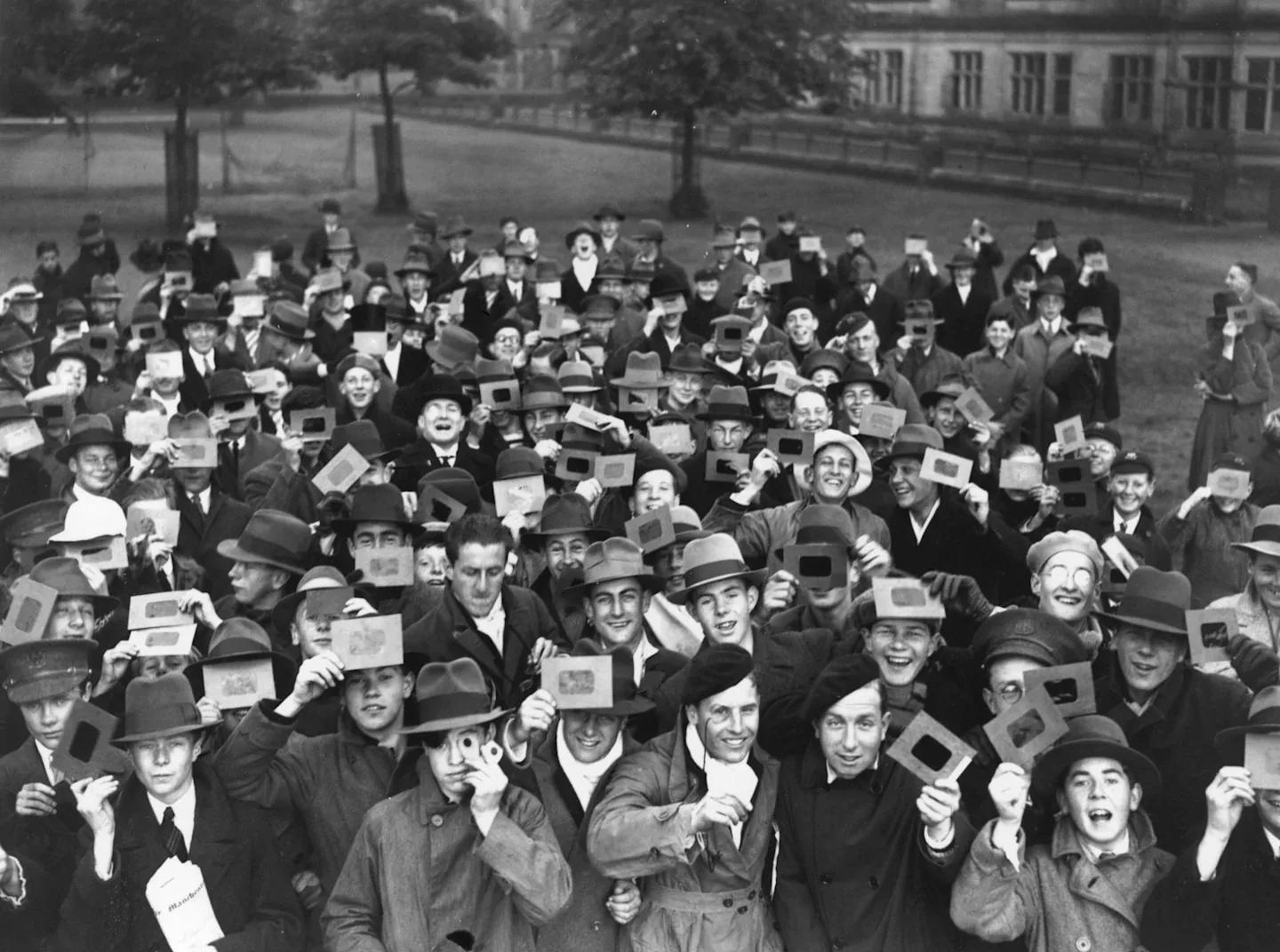 Photos of people looking at solar eclipses from 1907 to the present day