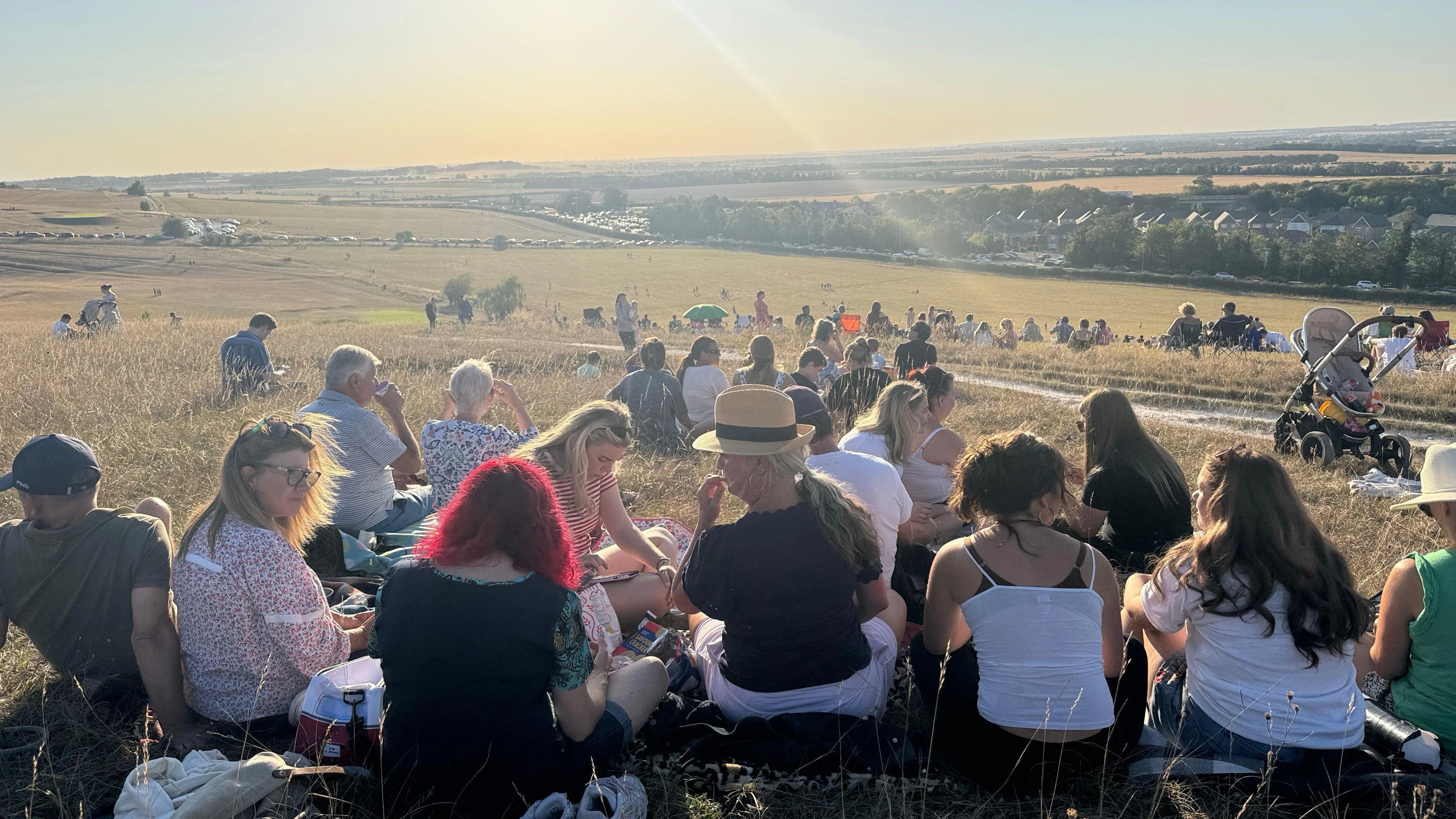 Hundreds gather to watch eclipse on hillside - AOL