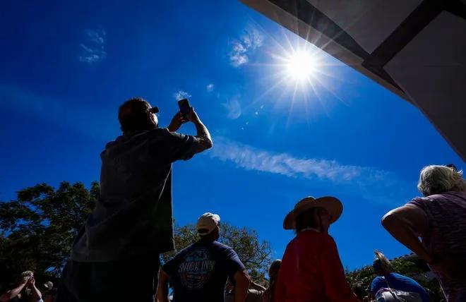 Naples crowds watch solar eclipse from Collier library courtyard