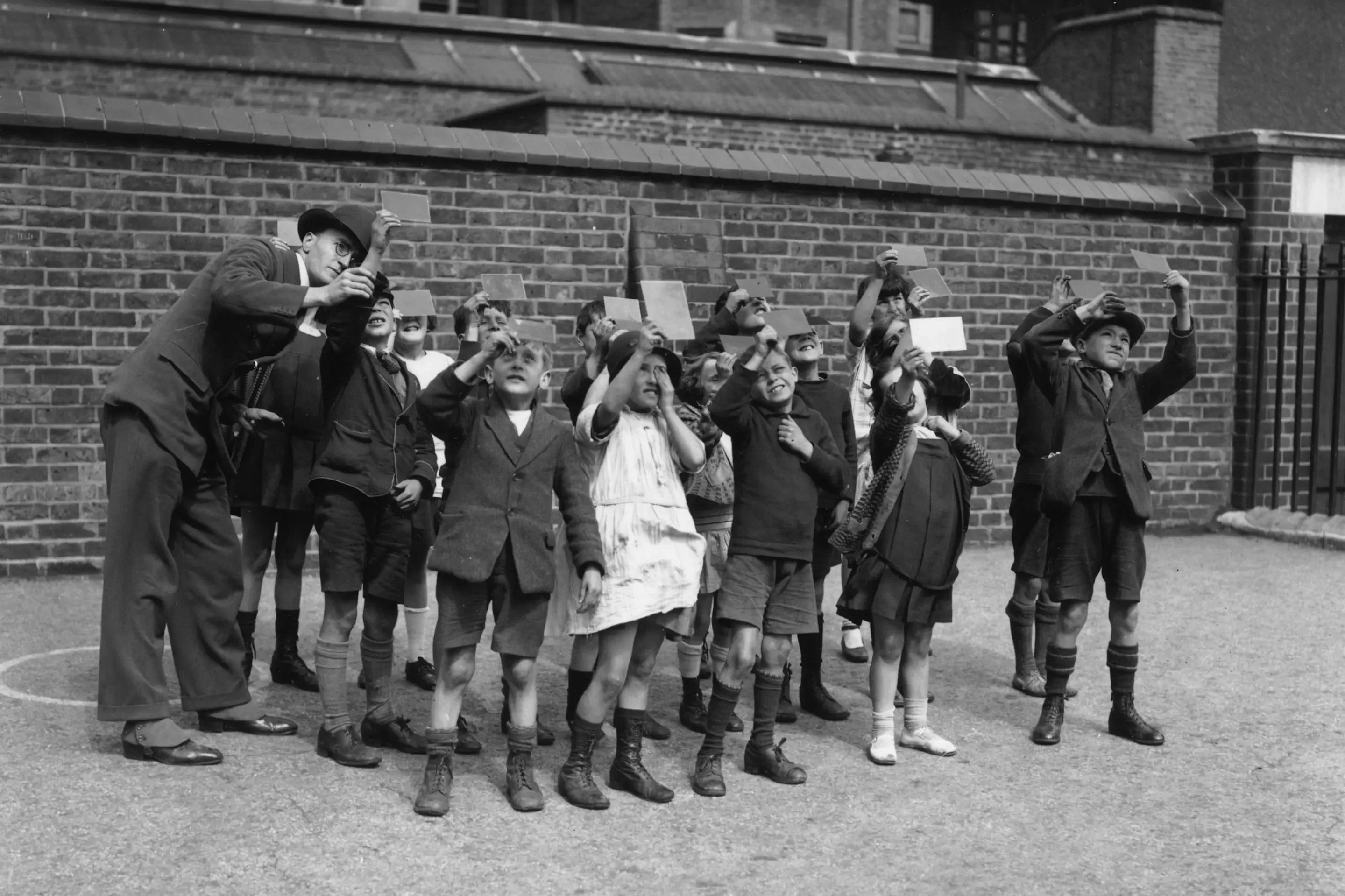 Photos of people looking at solar eclipses from 1907 to the present day