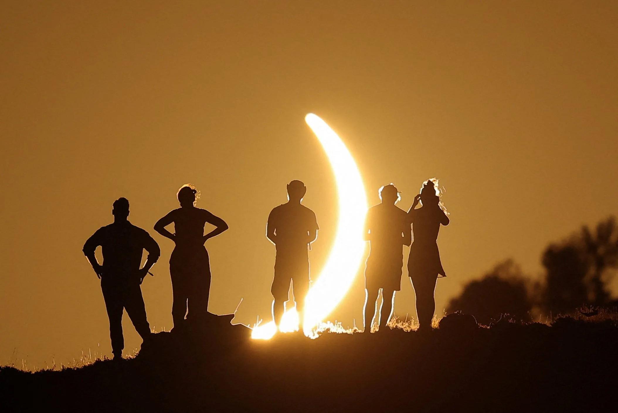 Rare solar eclipse draws crowds of people around the world. See photos