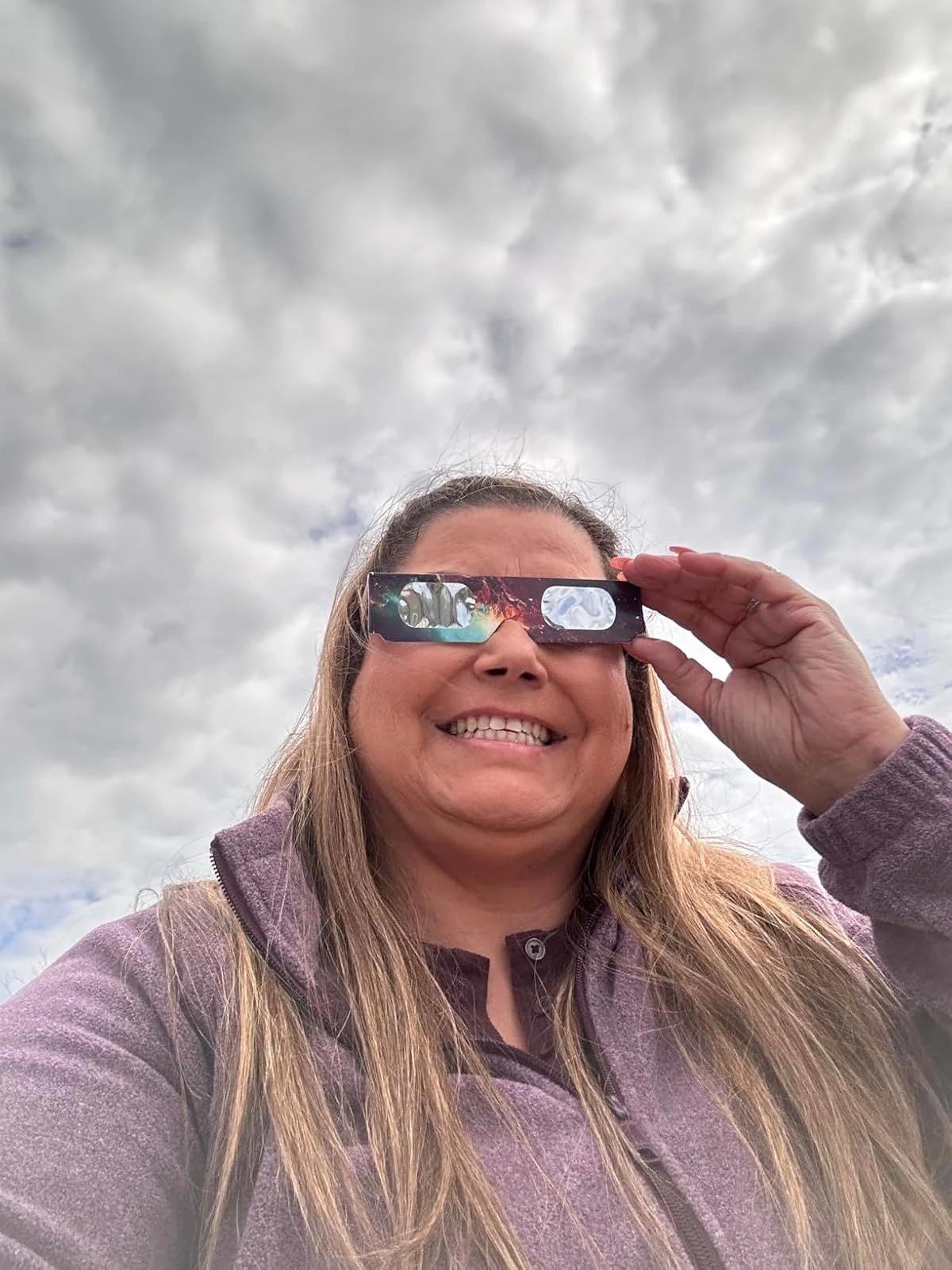 woman selfie wearing eclipse glasses cloudy sky outdoor — people viewing the eclipse with protective glasses