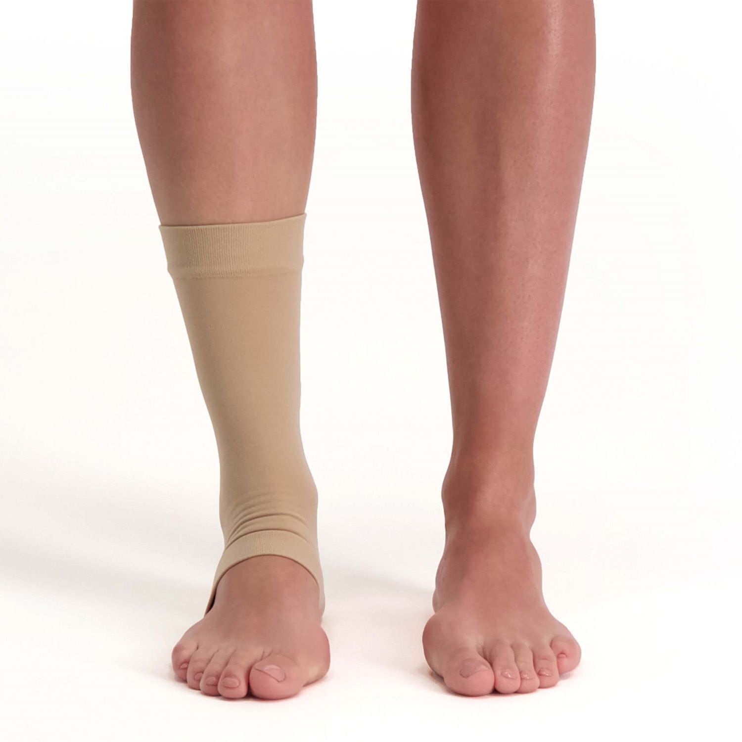 Front view of model wearing the Solelution Achilles Tendon Gel Sock - Beige around the right ankle