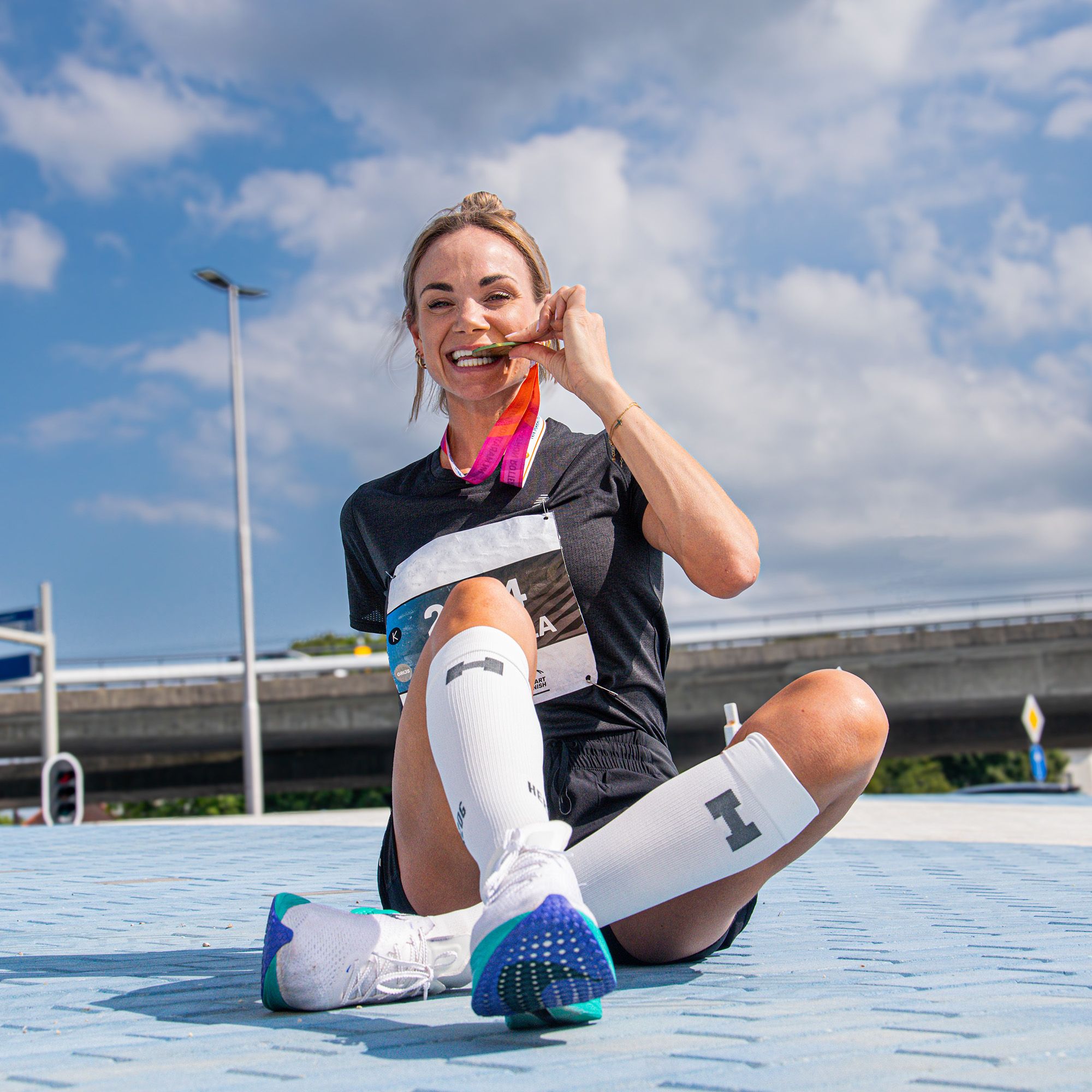 Herzog Sport Compression Stockings in the colour white worn by female runner medalist