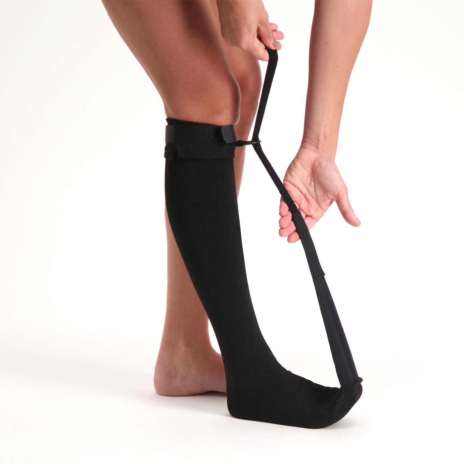 Heel Spur Sock - Night Splint worn by model applying the velcro strap