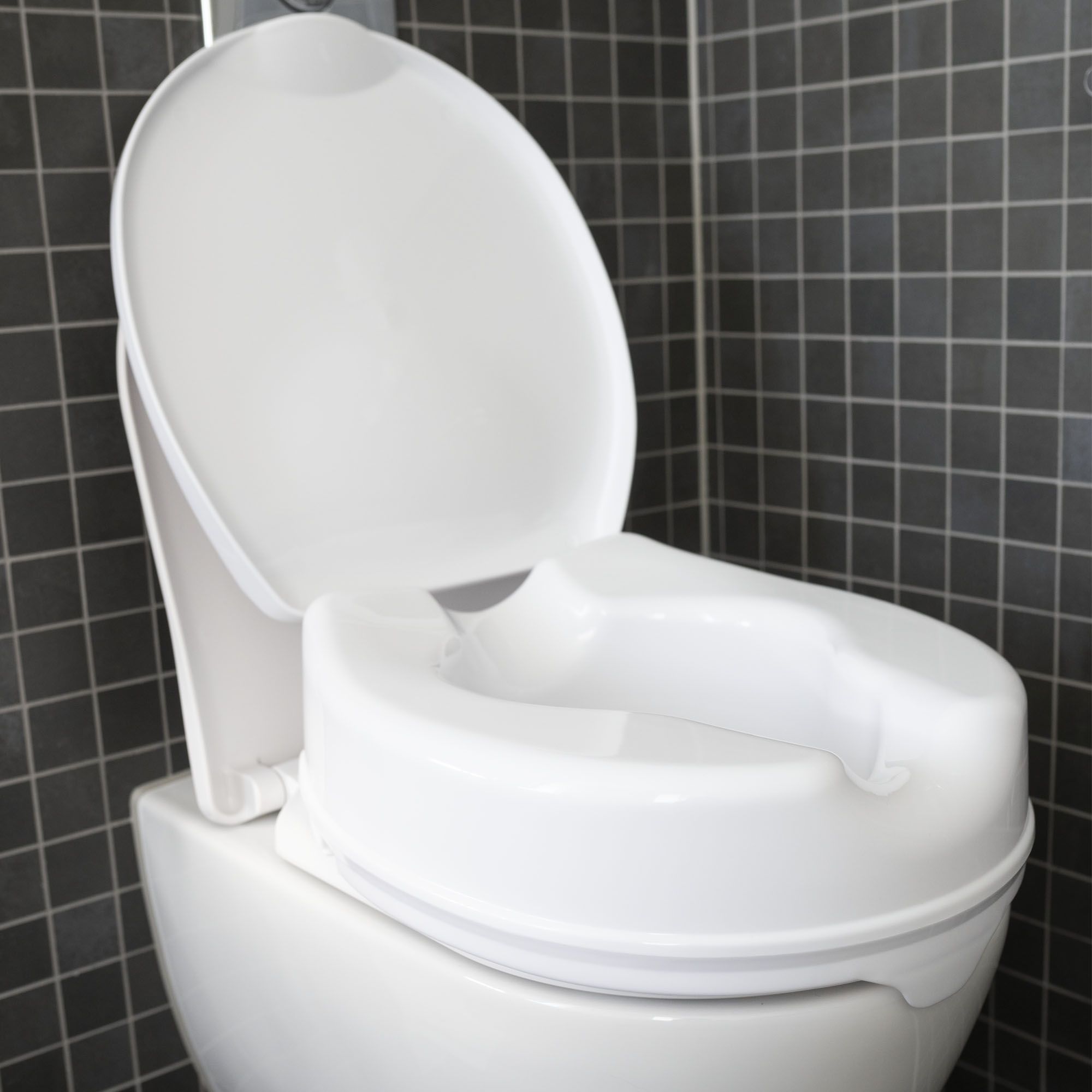 Toilet with the Dunimed Raised Toilet Seat mounted on it