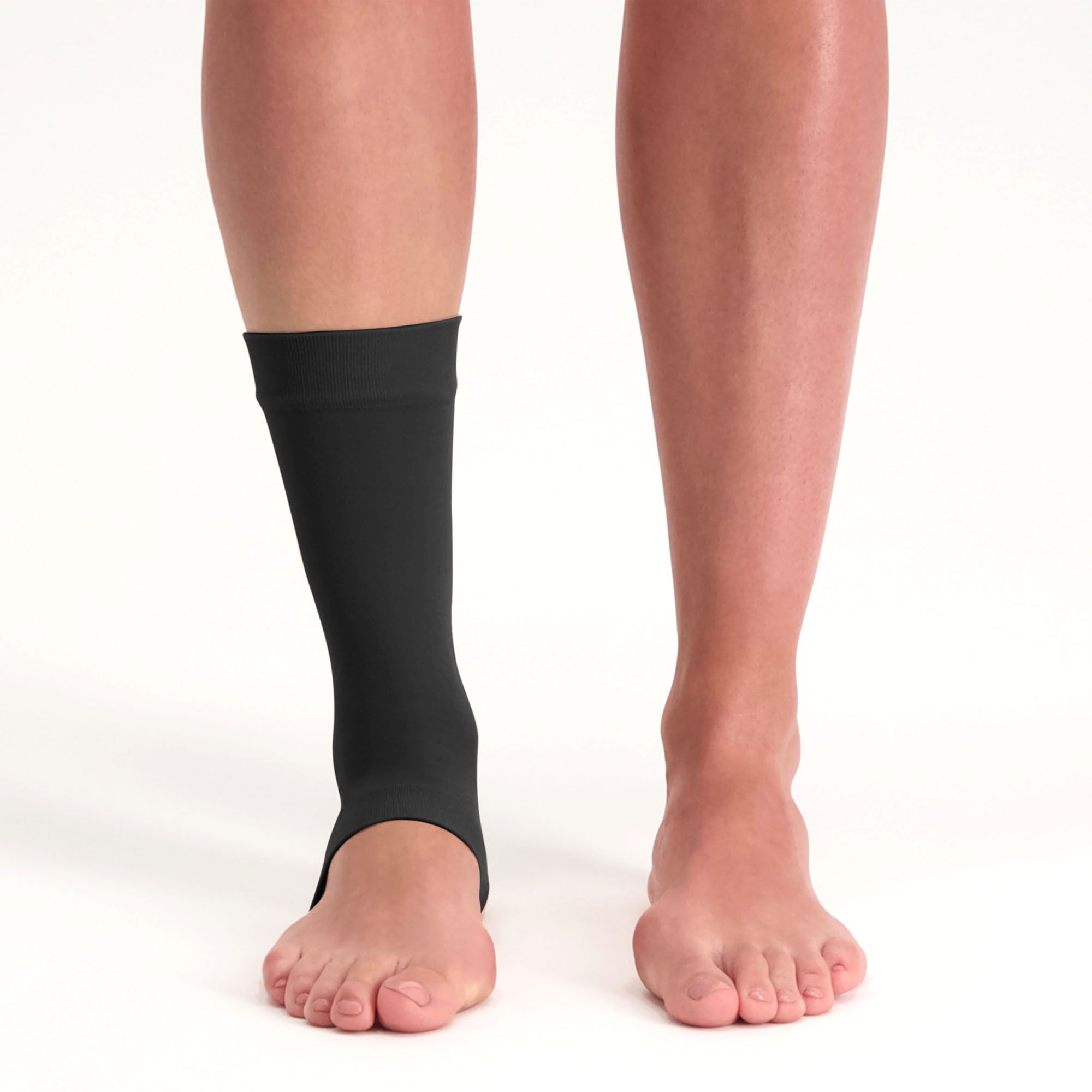 Front view of model wearing the Solelution Achilles Tendon Gel Sock - Black around the right ankle