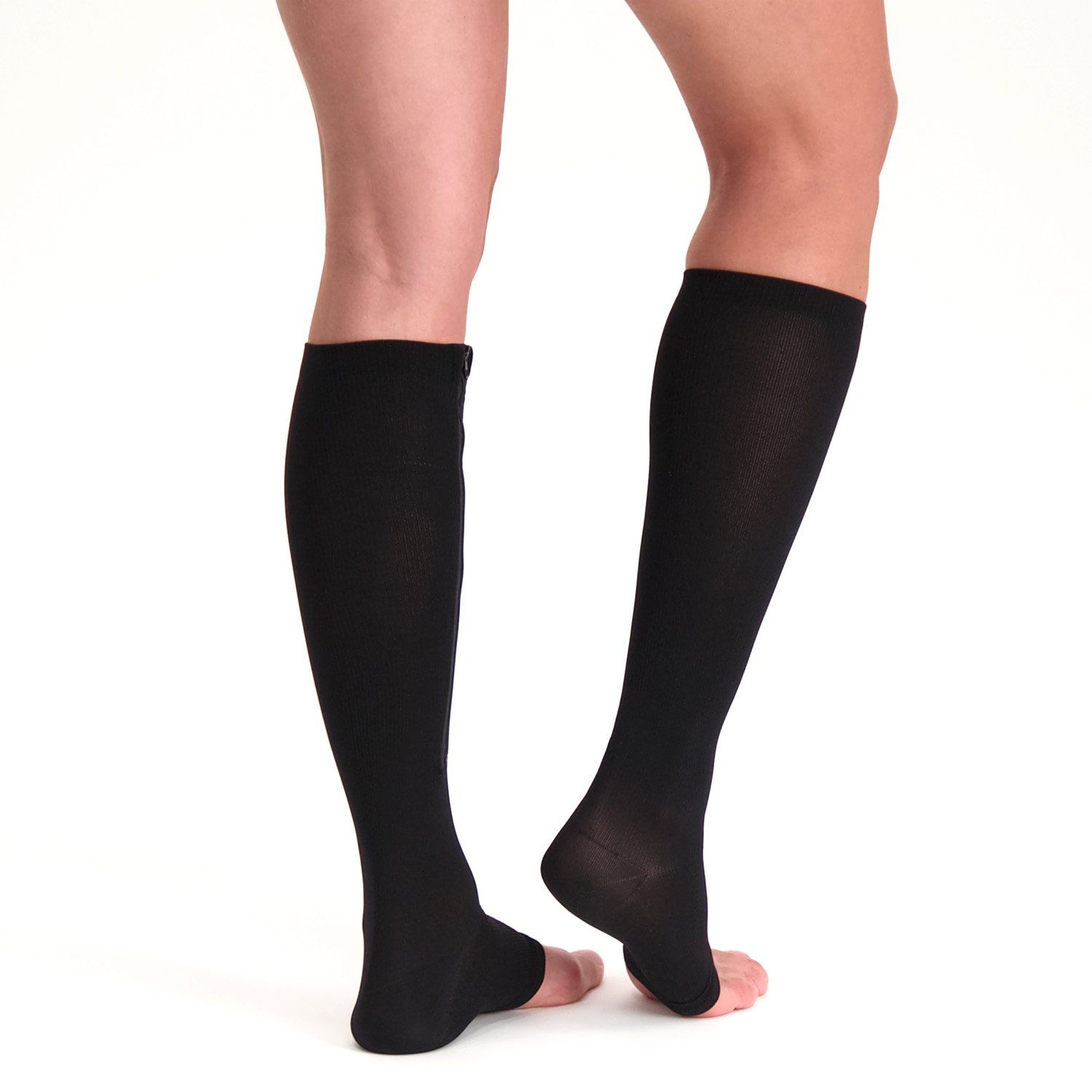 Back view of model wearing the Support Stockings with Zipper - Open Toe - Black on both legs