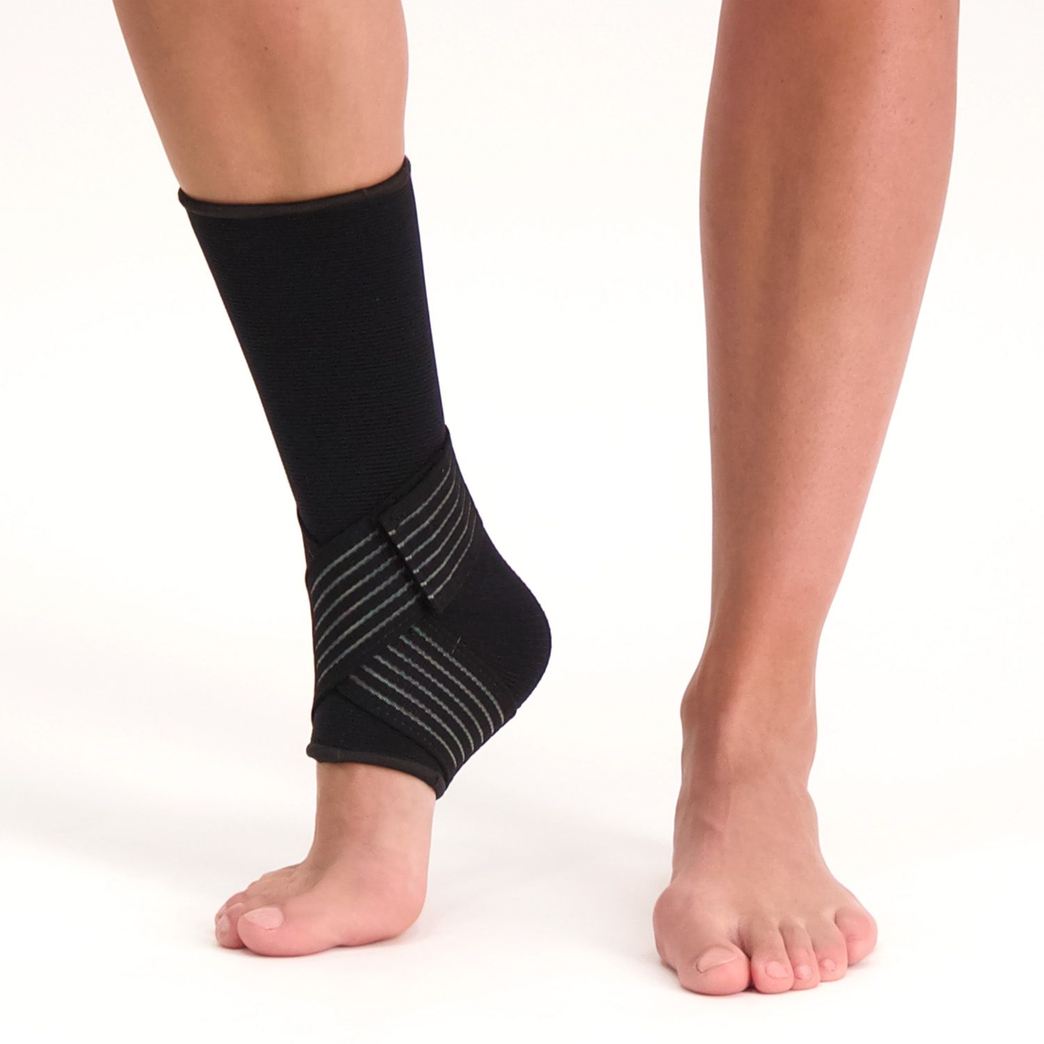 Front view of model wearing the Medidu Premium Ankle Support in Black while lifting the ankle up