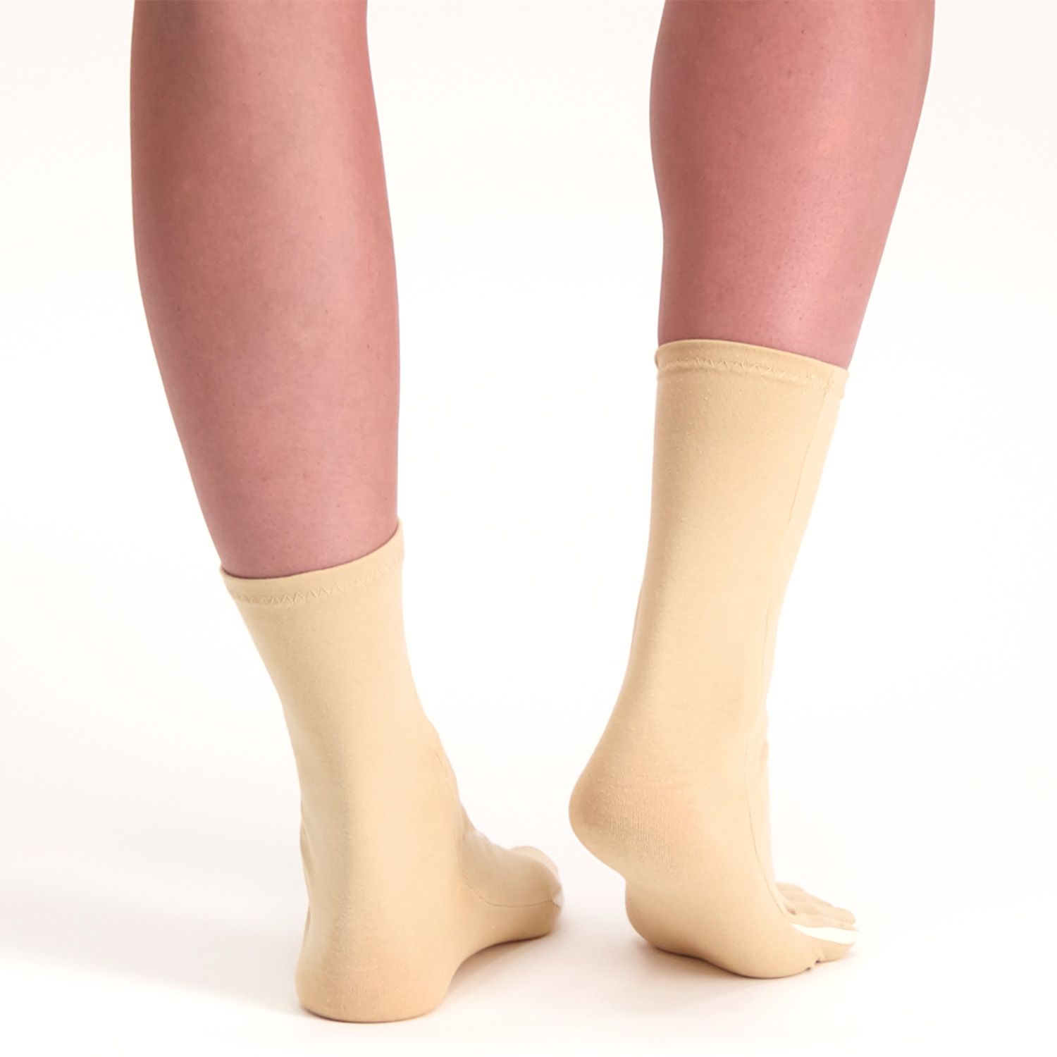 Back view of the Dunimed rheumatoid arthritis osteoarthritis socks in beige with right heel lifted