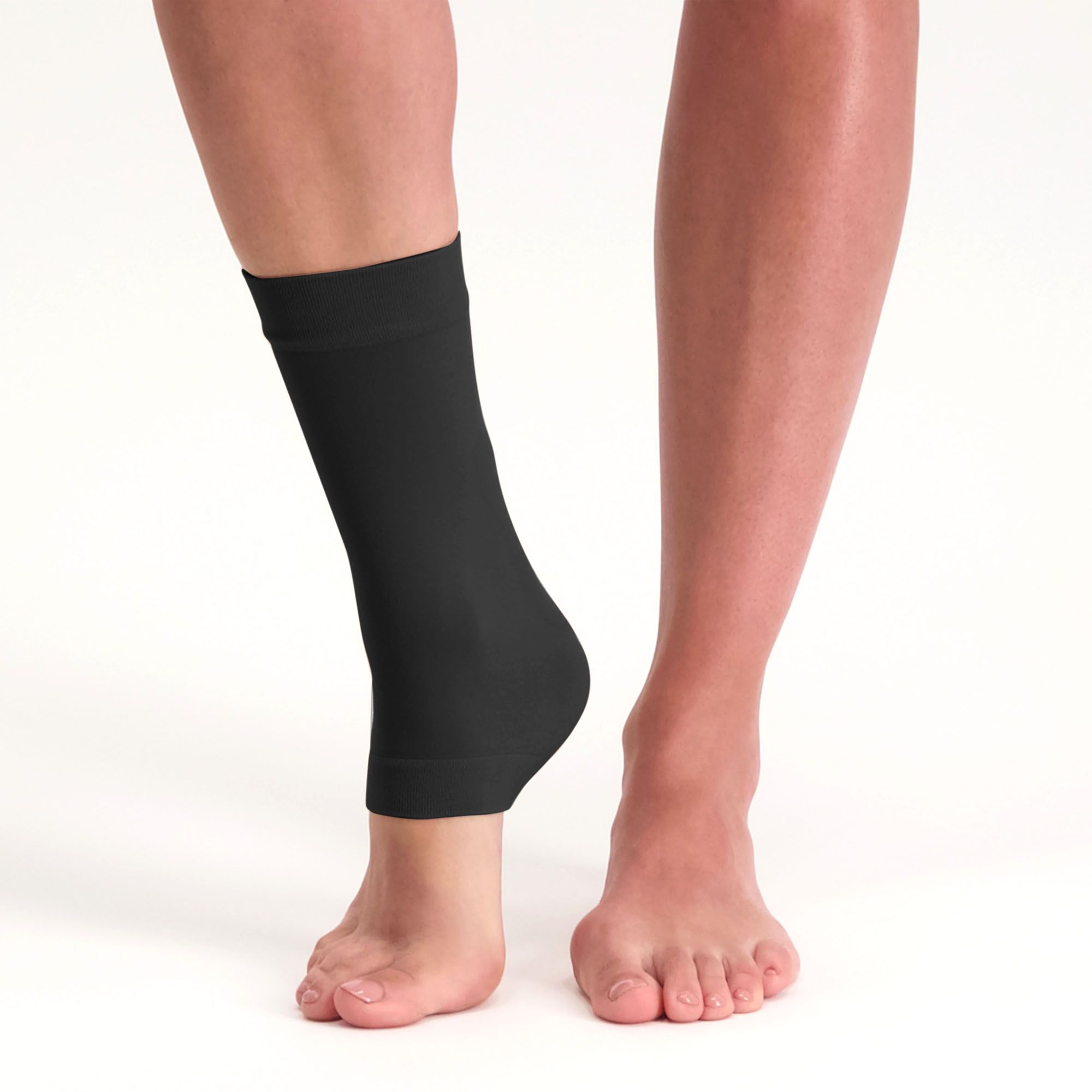 Solelution achilles tendon gel sock black worn by model around the right foot lifting the right heel up