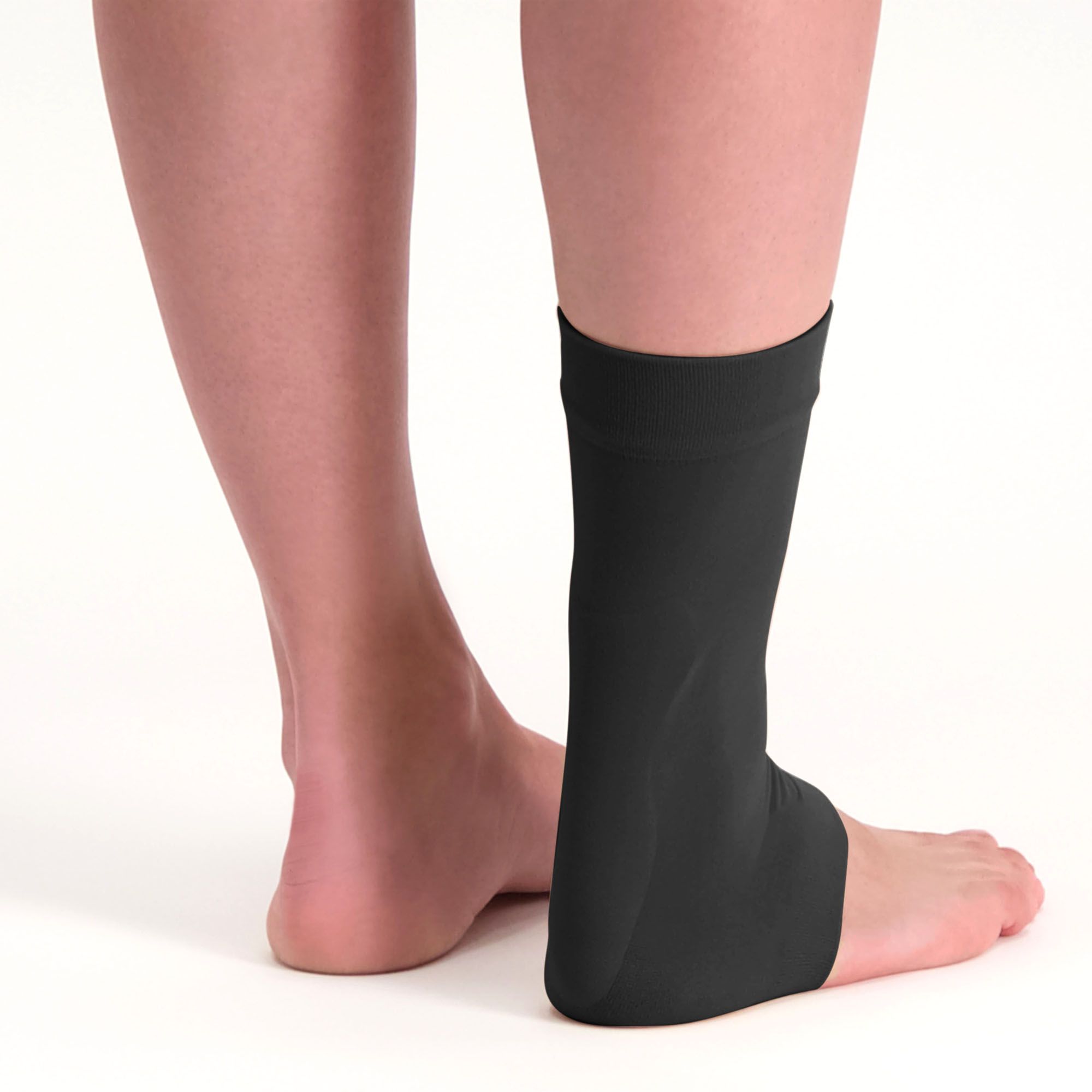 Back view of model wearing the Solelution Achilles Tendon Gel Sock - Black around right ankle